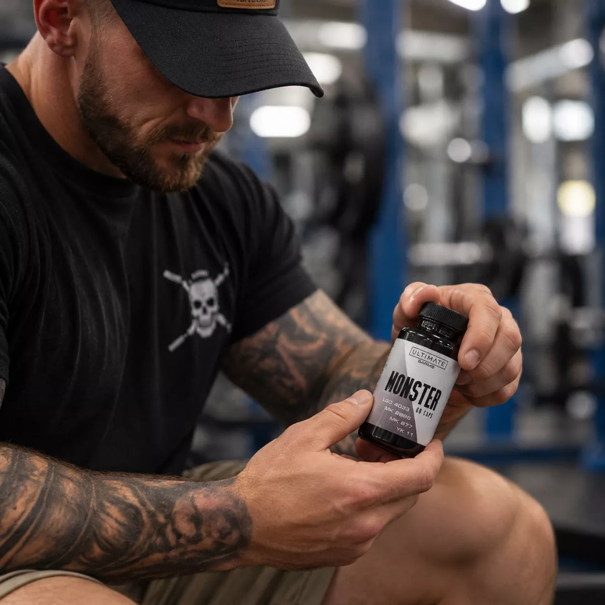 muscular athlete holding ultimate sarms bottle